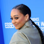 Tia Mowry’s Mystery Man Revealed After Packing On The PDA In Viral Smooching Snaps