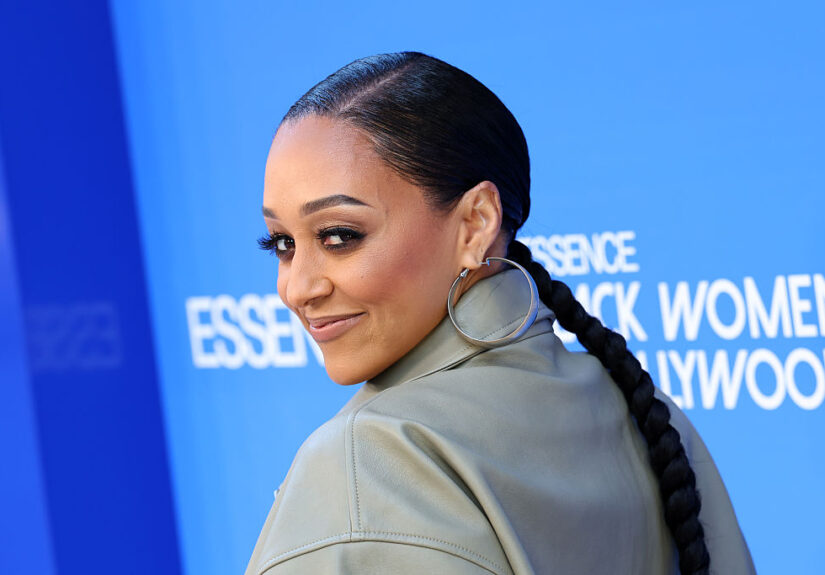 Tia Mowry’s Mystery Man Revealed After Packing On The PDA In Viral Smooching Snaps