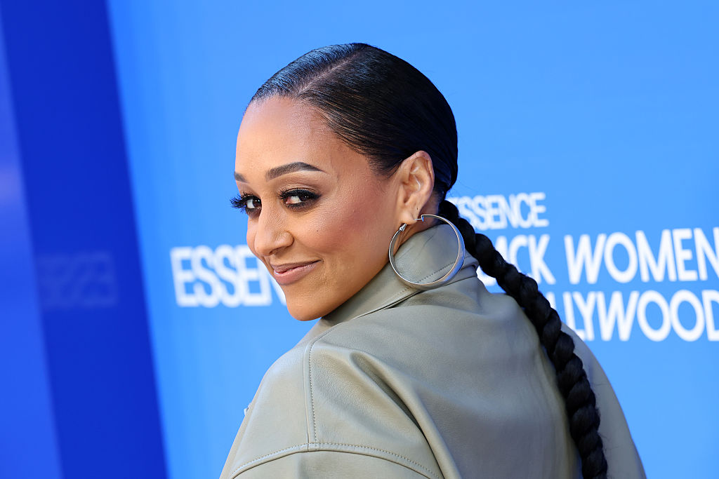 Tia Mowry’s Mystery Man Revealed After Packing On The PDA In Viral Smooching Snaps