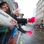 Too Busy Gloating: Runner Celebrates Too Early, Gets Beaten, But the Reaction of the Woman Holding the Finish Banner Goes Viral